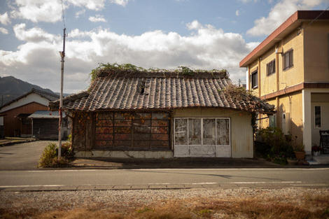 A building with a lopsided roof collapsing in a delightful way.