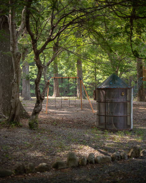Playground just behind Umedagani station, swingset nestled in what looks to be a very comfy bit of greenery.