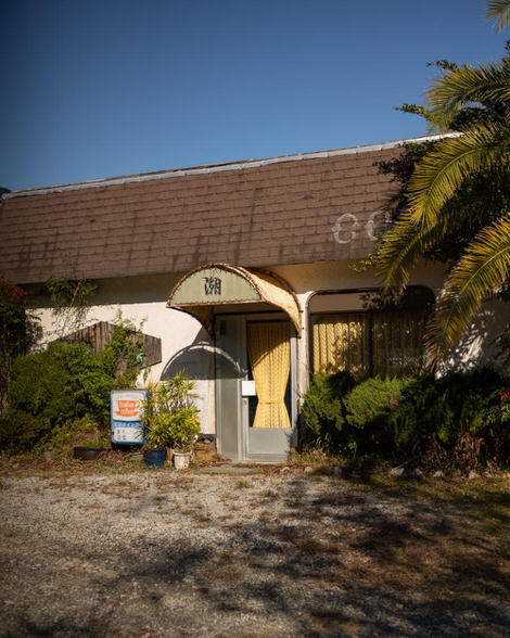 A long-since abandoned kissaten, the kanji for lake, Mizuumi on the front awning, the entrance windows cinched closed with yellow curtains.
