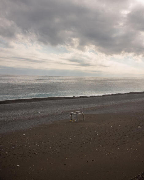 A bit of infrastructure? a concrete cube sitting on the beach with no other objects or humans nearby in the frame.