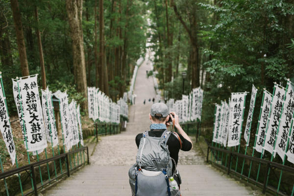 Craig Mod photographing down from Hongu Taisha on the steps of the shrine